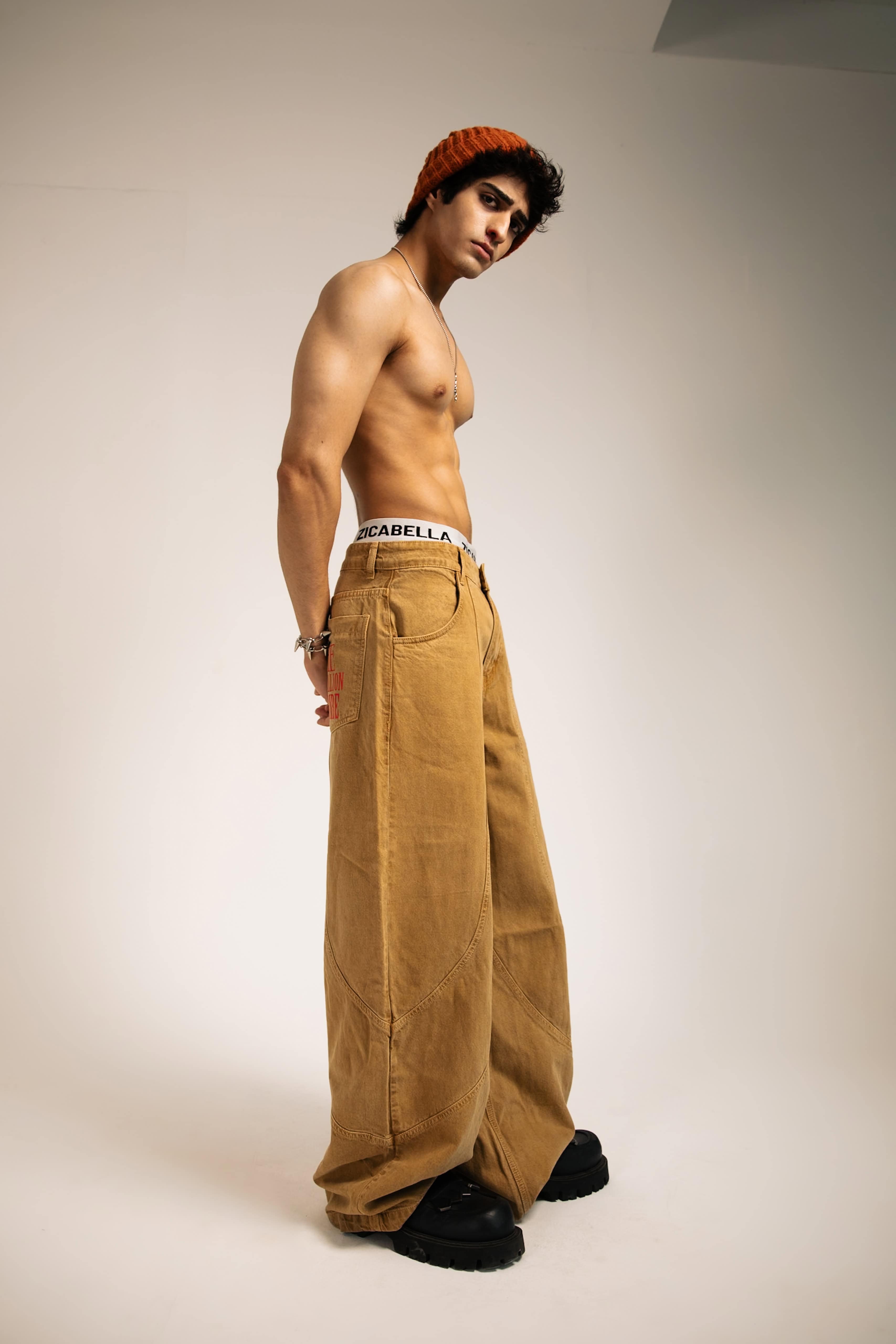 Relaxed fit beige cotton jeans, designed for contemporary streetwear fashion