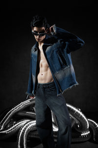 blue denim jacket with zipper closure and raw edge detailing in a casual fit