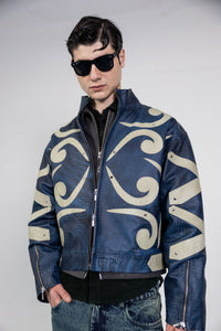 Model wearing blue embossed leather jacket with beige appliqué details