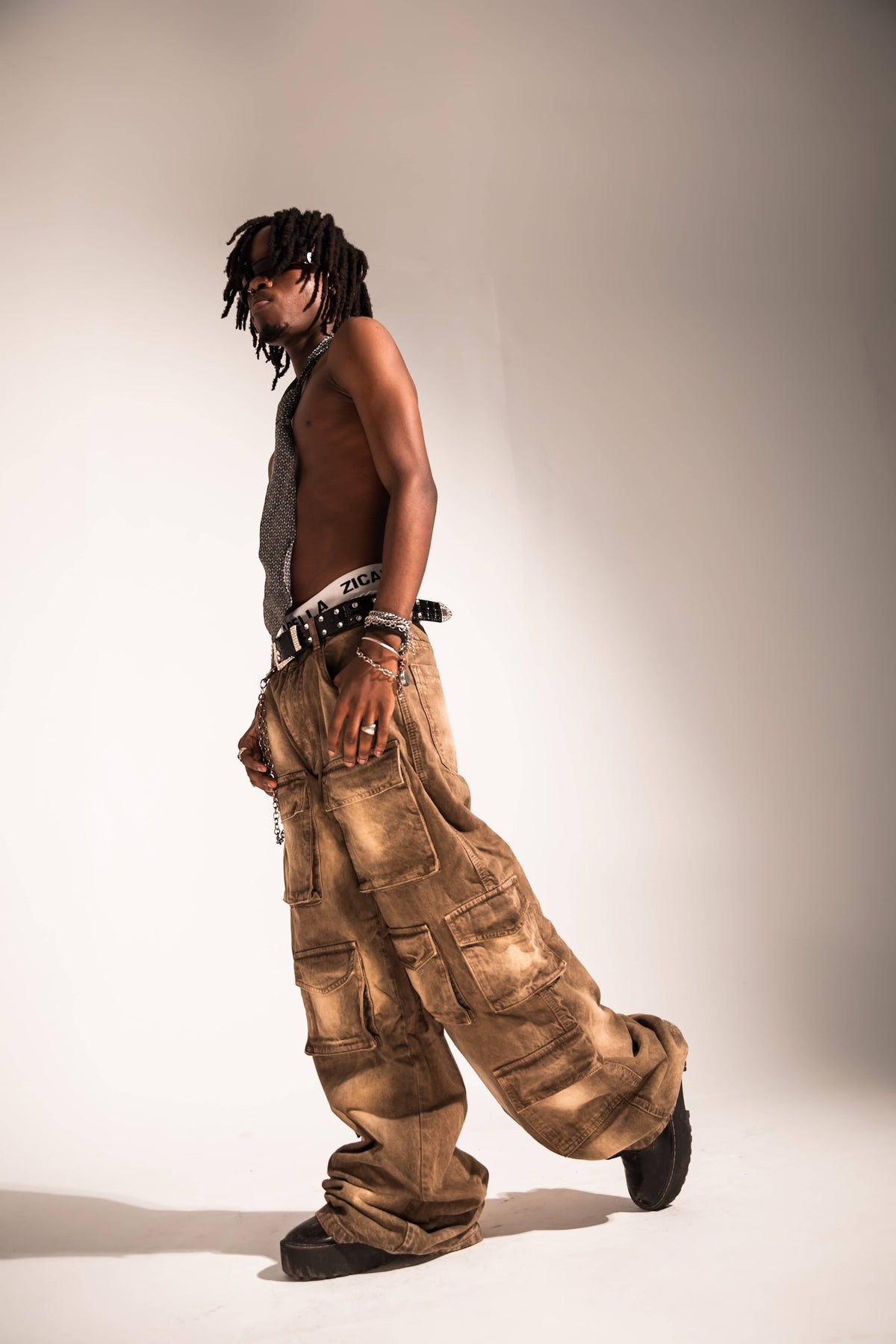 acid washed brown denim cargo in a baggy streetwear silhouette with structured side pockets and a heavy drape