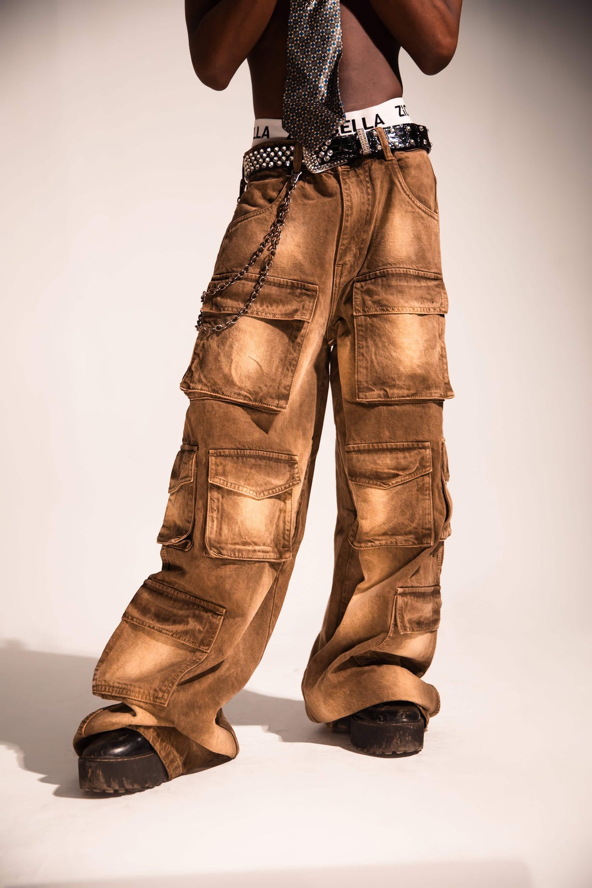Relaxed fit brown denim cargo with a flowing streetwear silhouette and distressed textured finish.
