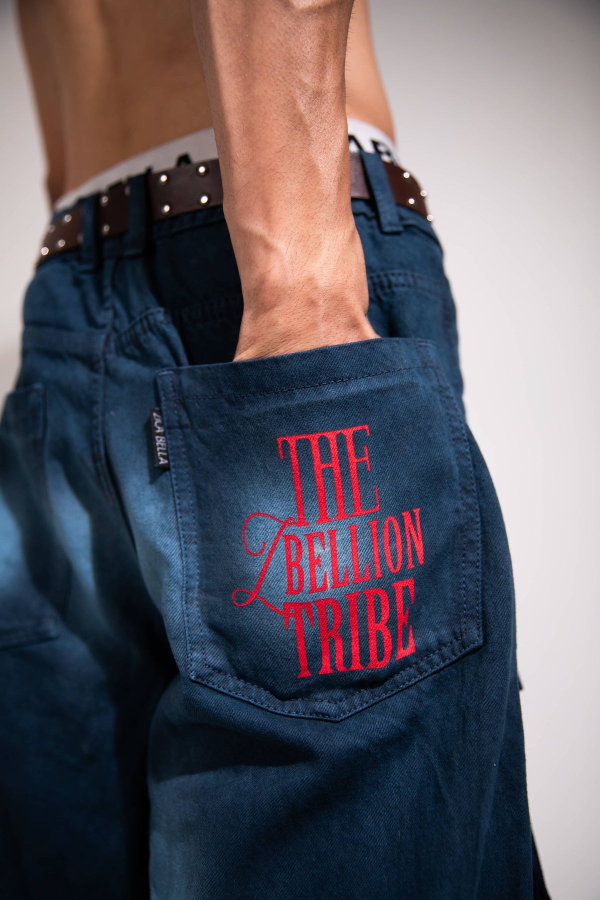 Dark blue heavyweight denim cargo showcasing utility pocket detail and streetwear design