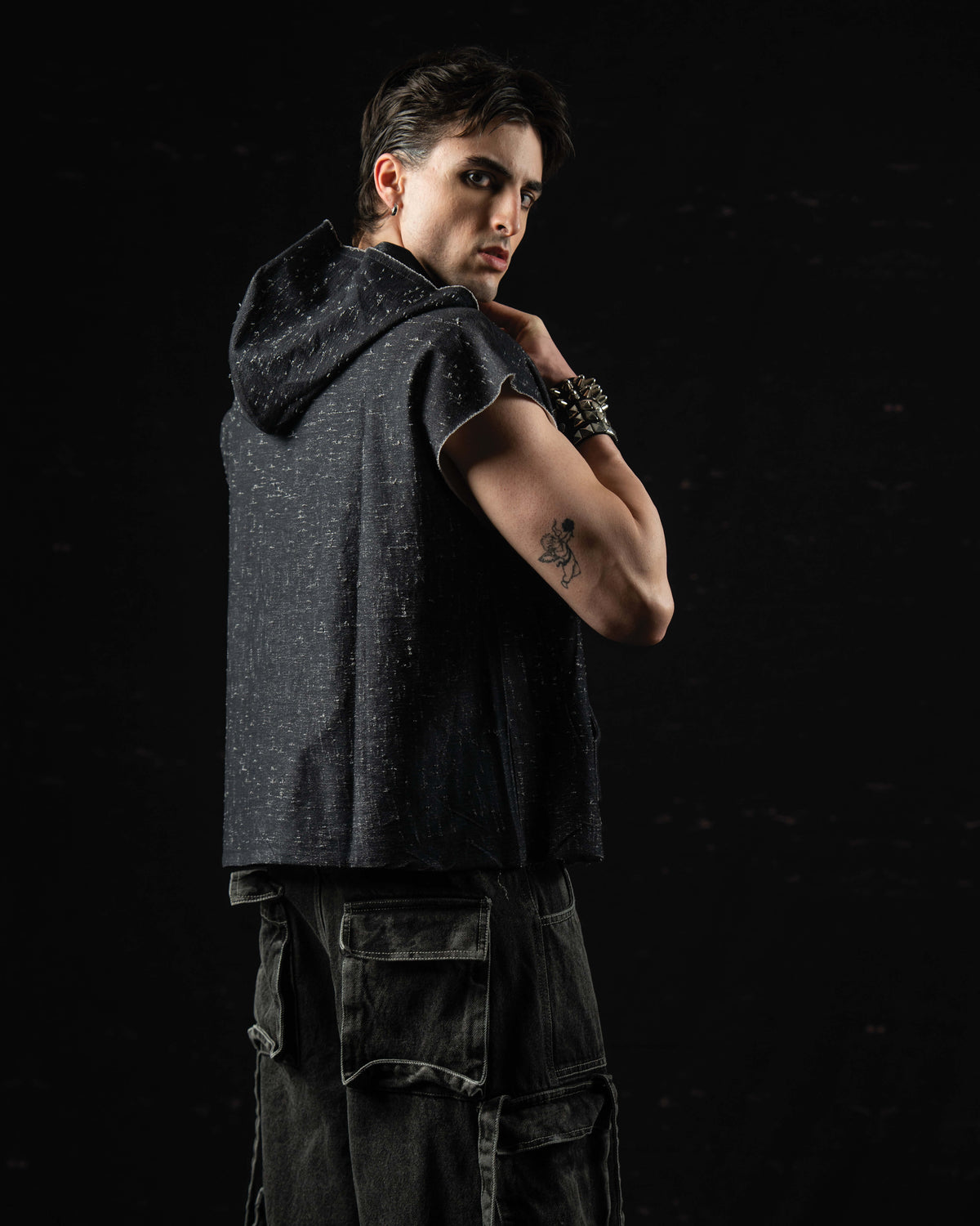 Back view of a washed charcoal oversized hooded graphic tee showcasing its relaxed drape
