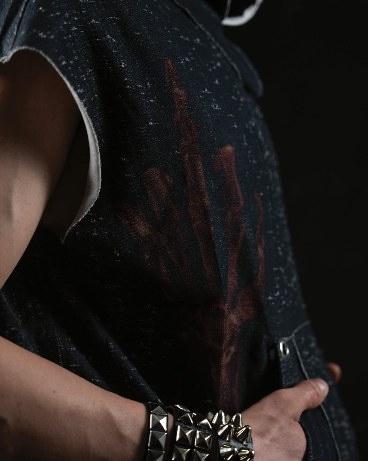 Close-up detail of vintage mythic artwork printed on a washed charcoal oversized hooded tee