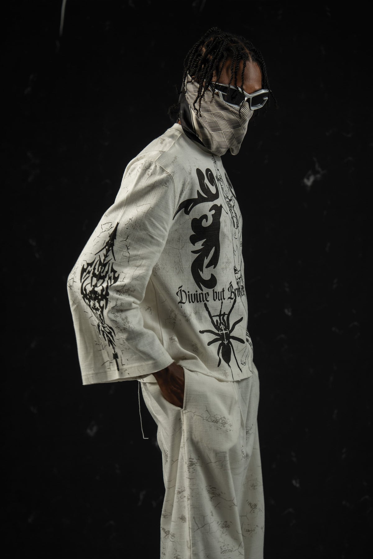 Side profile of a darkwear full sleeve t-shirt showcasing a relaxed gothic streetwear silhouette