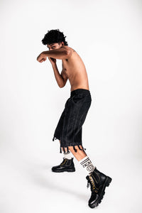side view of denim jorts, featuring fringed detail for a unique premium street look