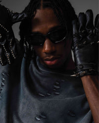 Close up of DRYXEN distressed oversized black t-shirt styled with black gloves