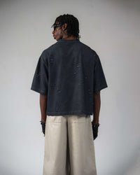 Back view of oversized distressed black streetwear t-shirt