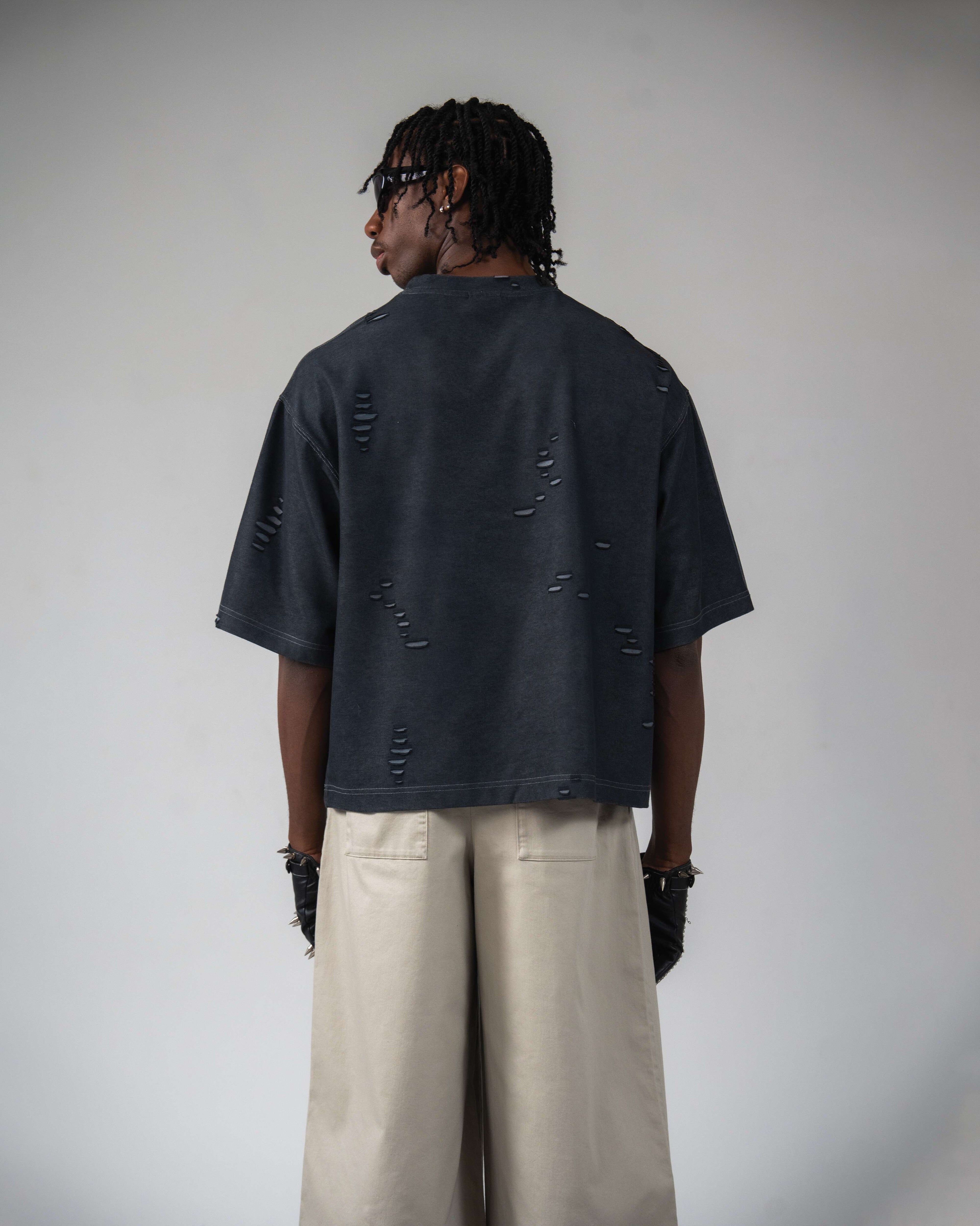 Back view of oversized distressed black streetwear t-shirt