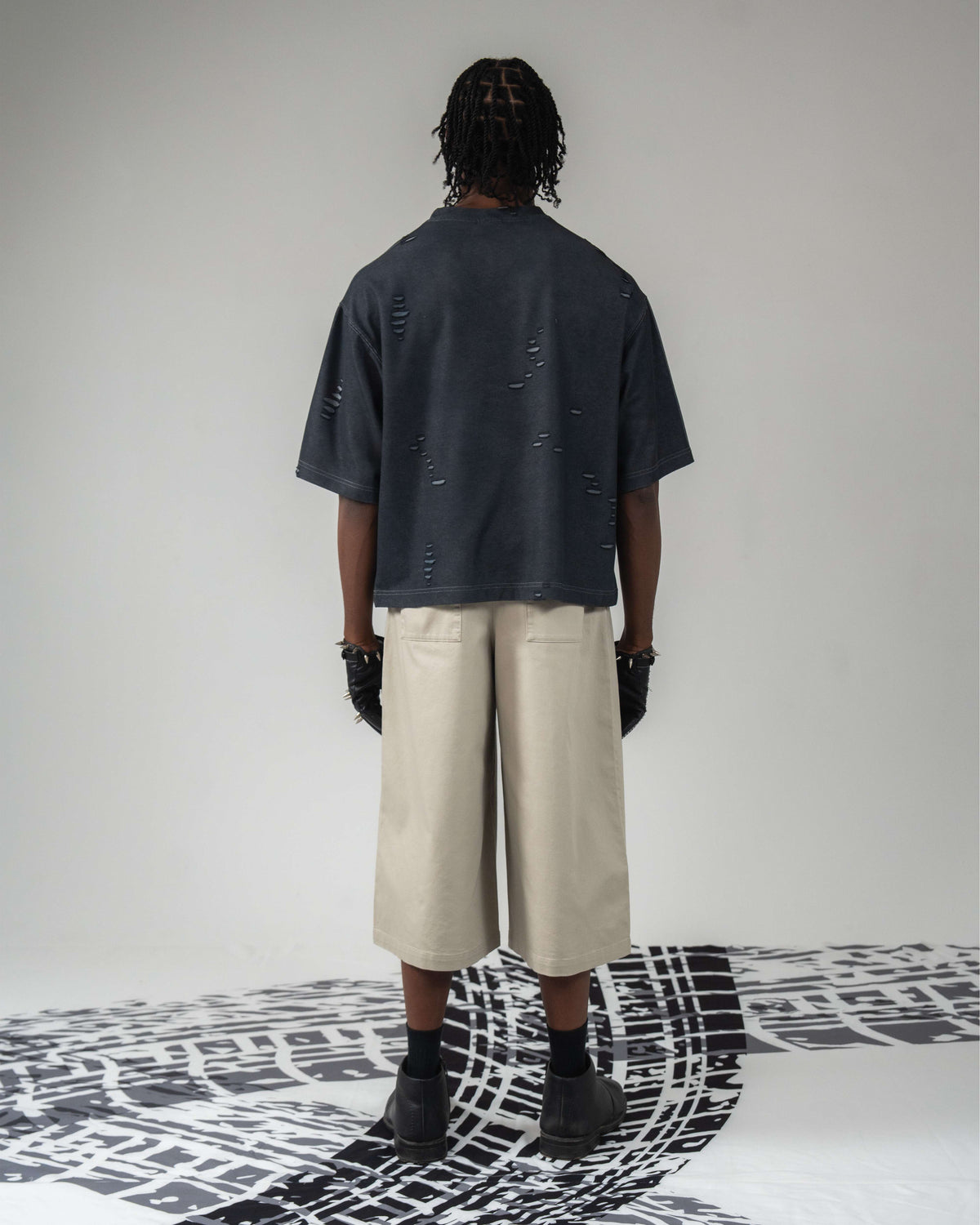 Full back body shot wearing oversized distressed t-shirt
