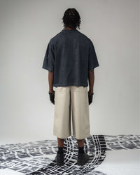 Full back body shot wearing oversized distressed t-shirt
