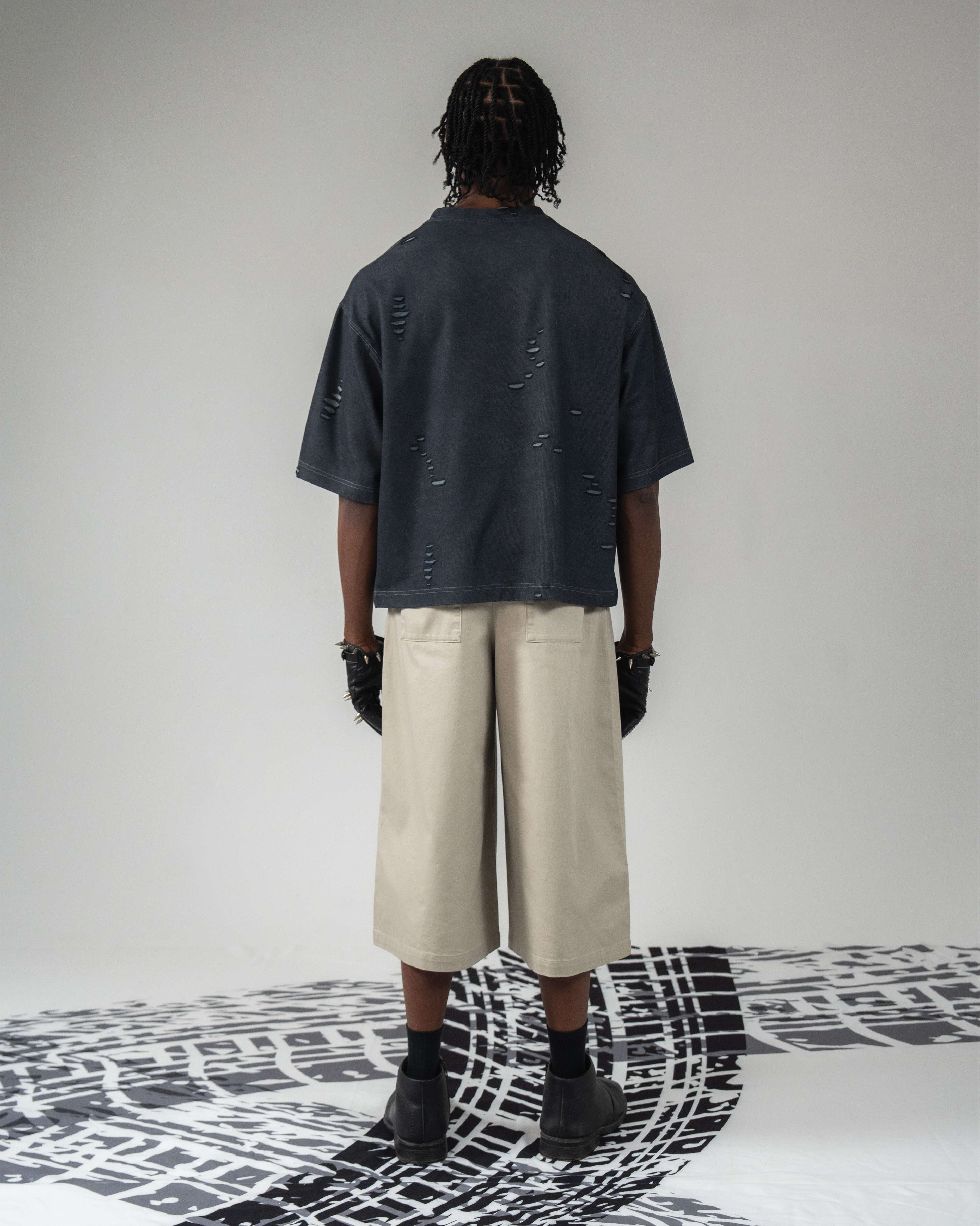 Full back body shot wearing oversized distressed t-shirt