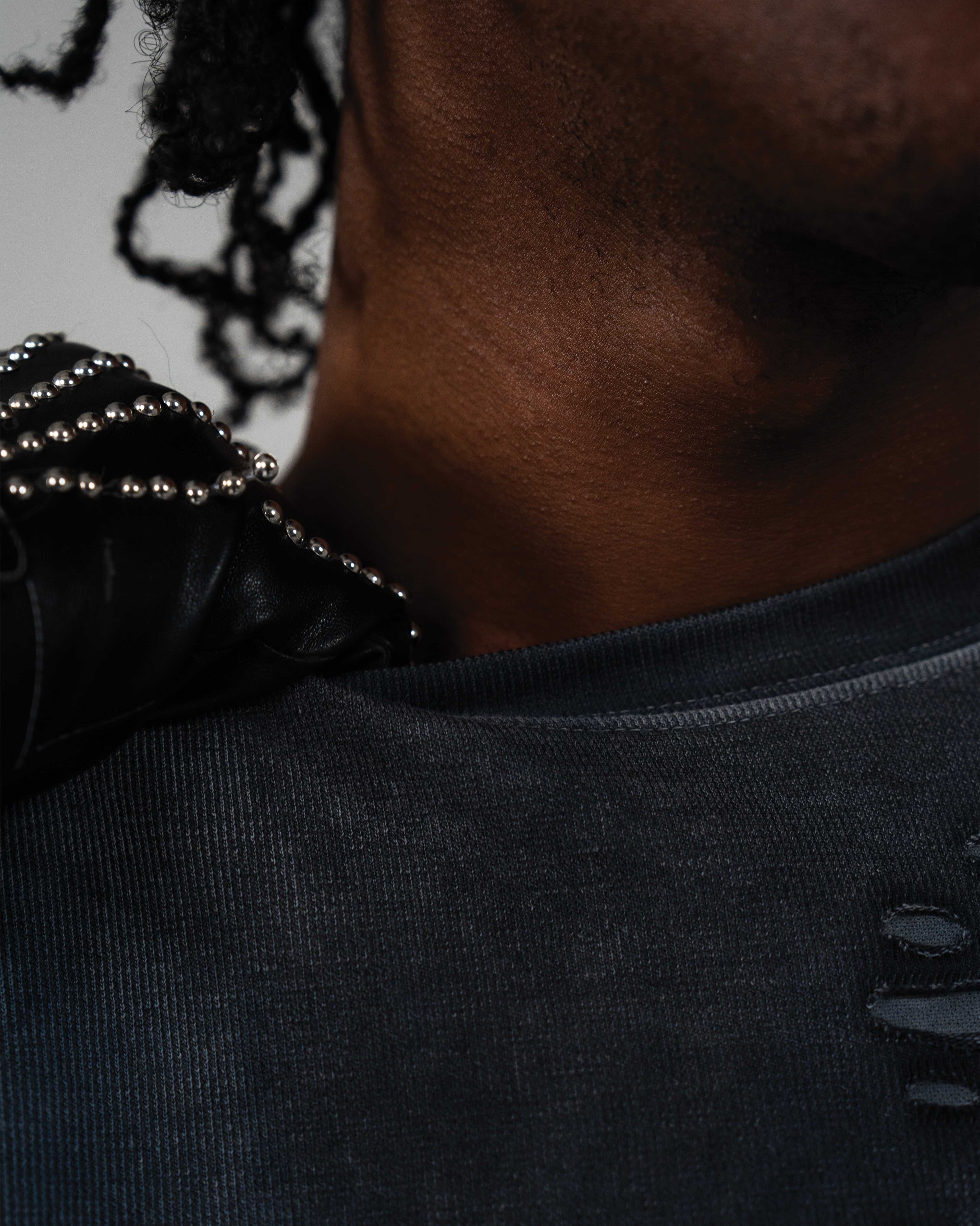 Close up detail of t-shirt neckline and distressed texture