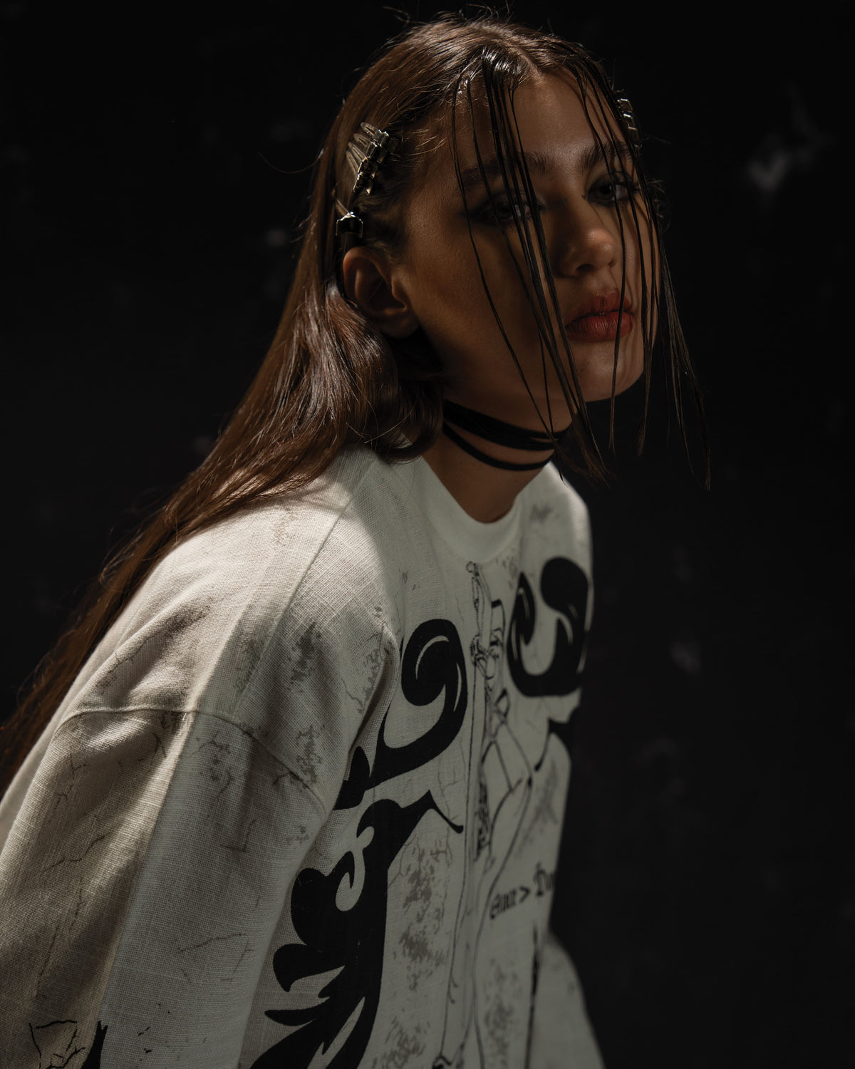Female model wearing a gothic darkwear full sleeve t-shirt styled for a modern streetwear editorial