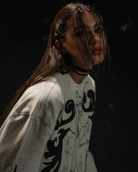 Female model wearing a gothic darkwear full sleeve t-shirt styled for a modern streetwear editorial