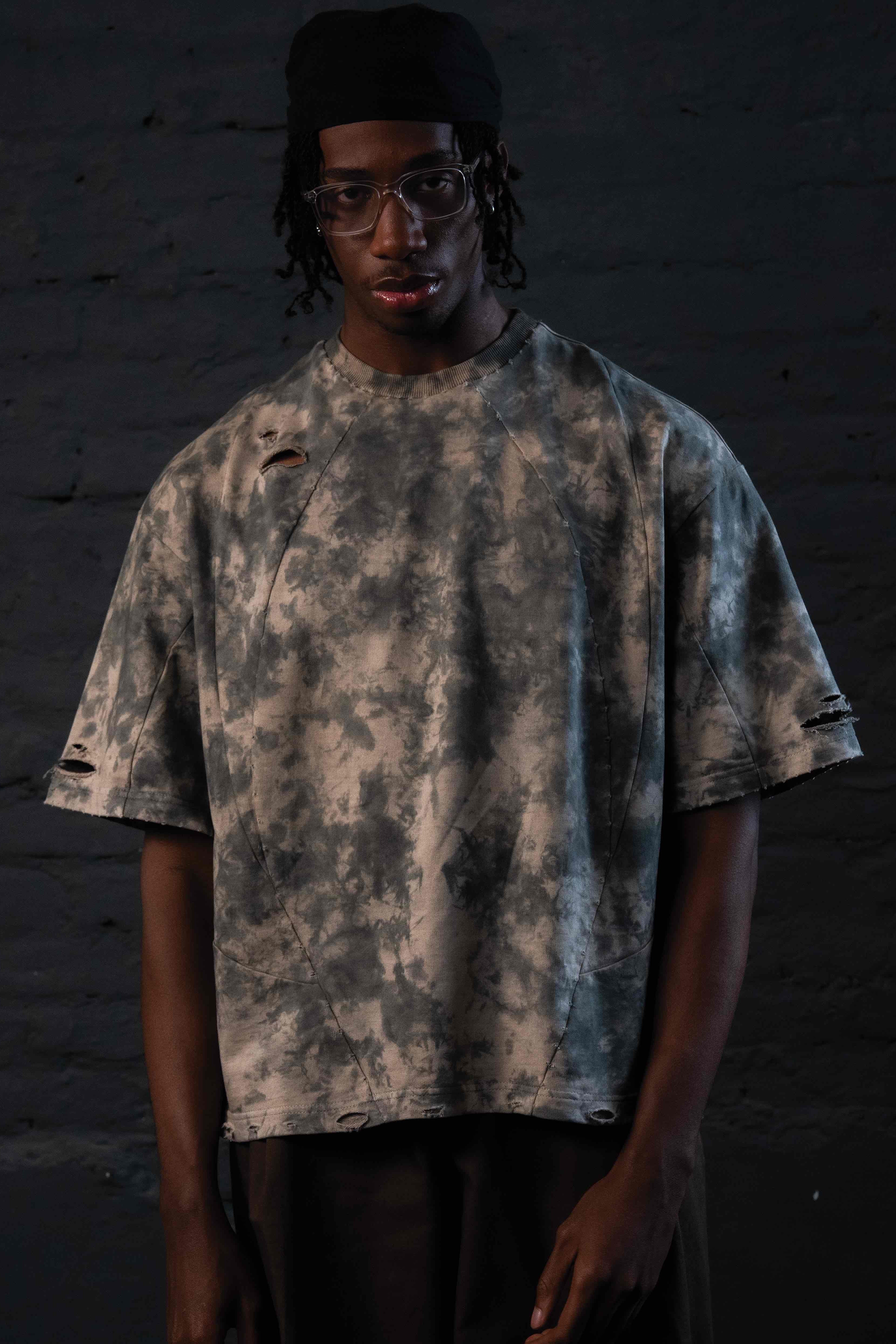 Studio portrait of GRAINDUST RAW TEE oversized distressed luxury streetwear tee