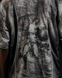 Extreme close-up of the back artwork detail printed on a grey and black oversized jersey