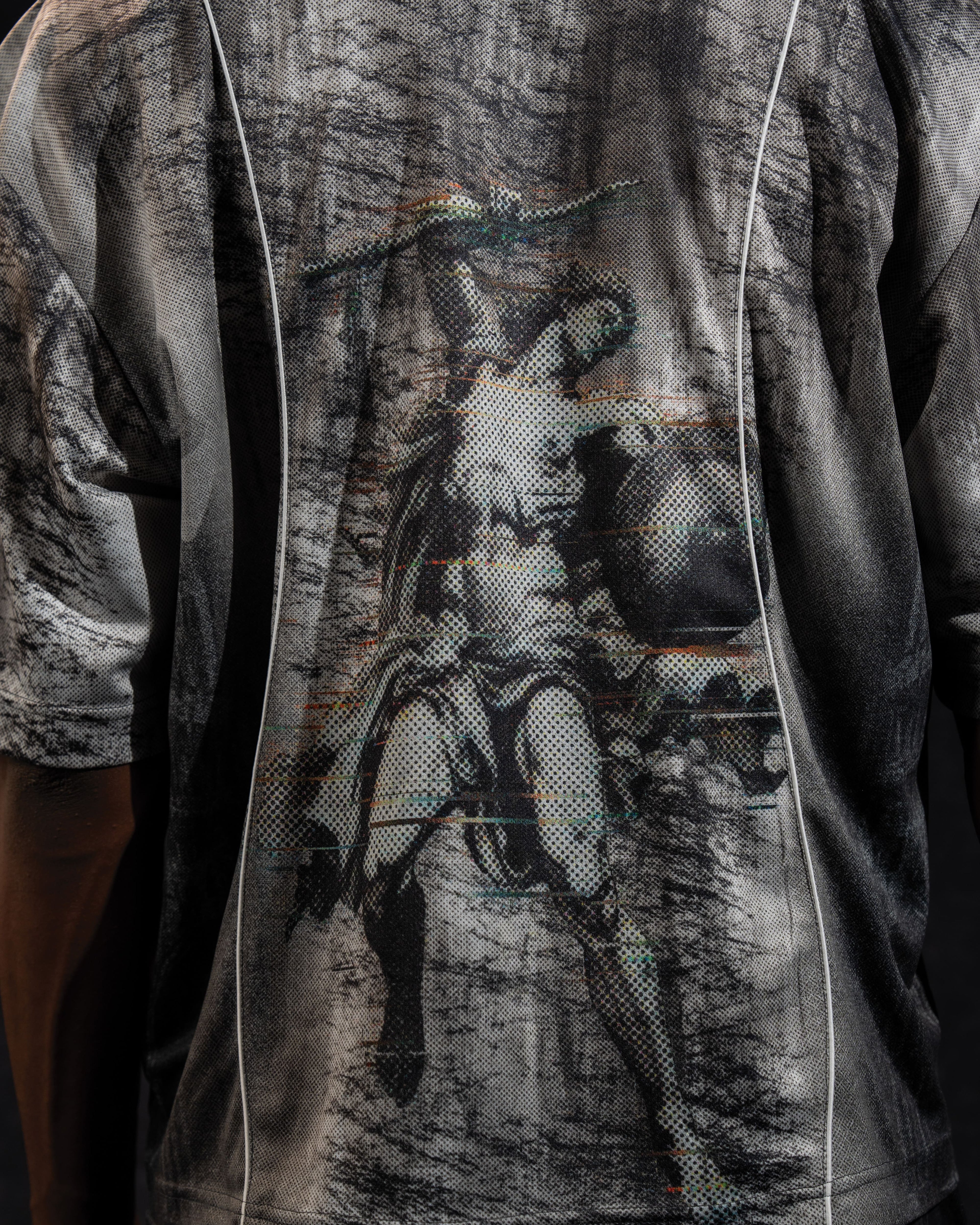 Extreme close-up of the back artwork detail printed on a grey and black oversized jersey