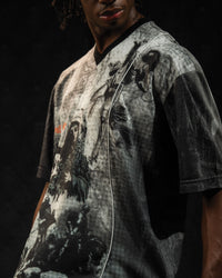 Close-up detail of the front graphic print on a grey and black oversized graphic jersey