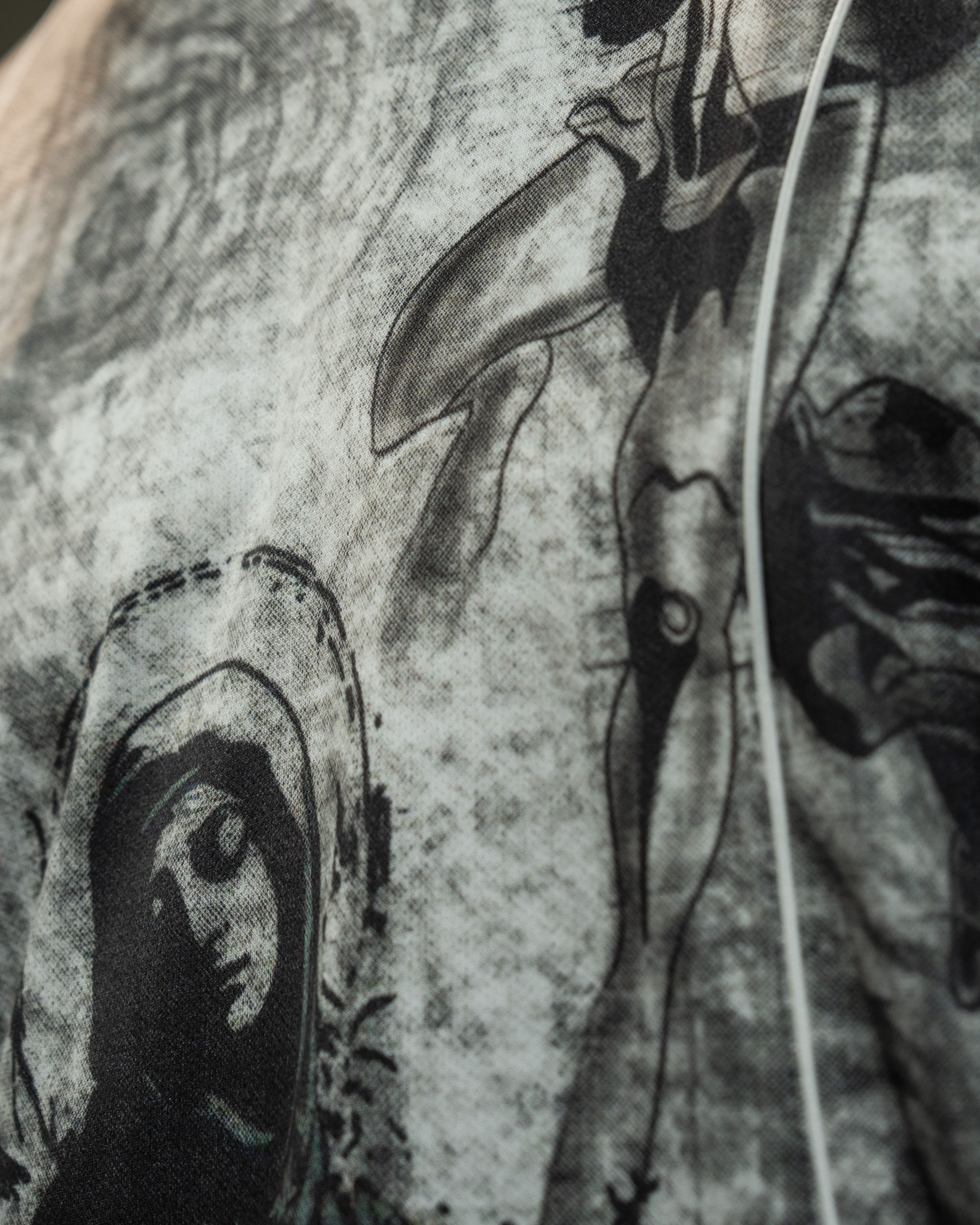 Close-up view of the premium illustrated print on the chest of an oversized lifestyle jersey