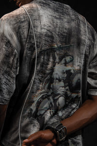 Close up back view showing the large graphic artwork printed on a grey and black oversized jersey