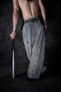 Back view of grey baggy lower showing relaxed fit and modern urban silhouette