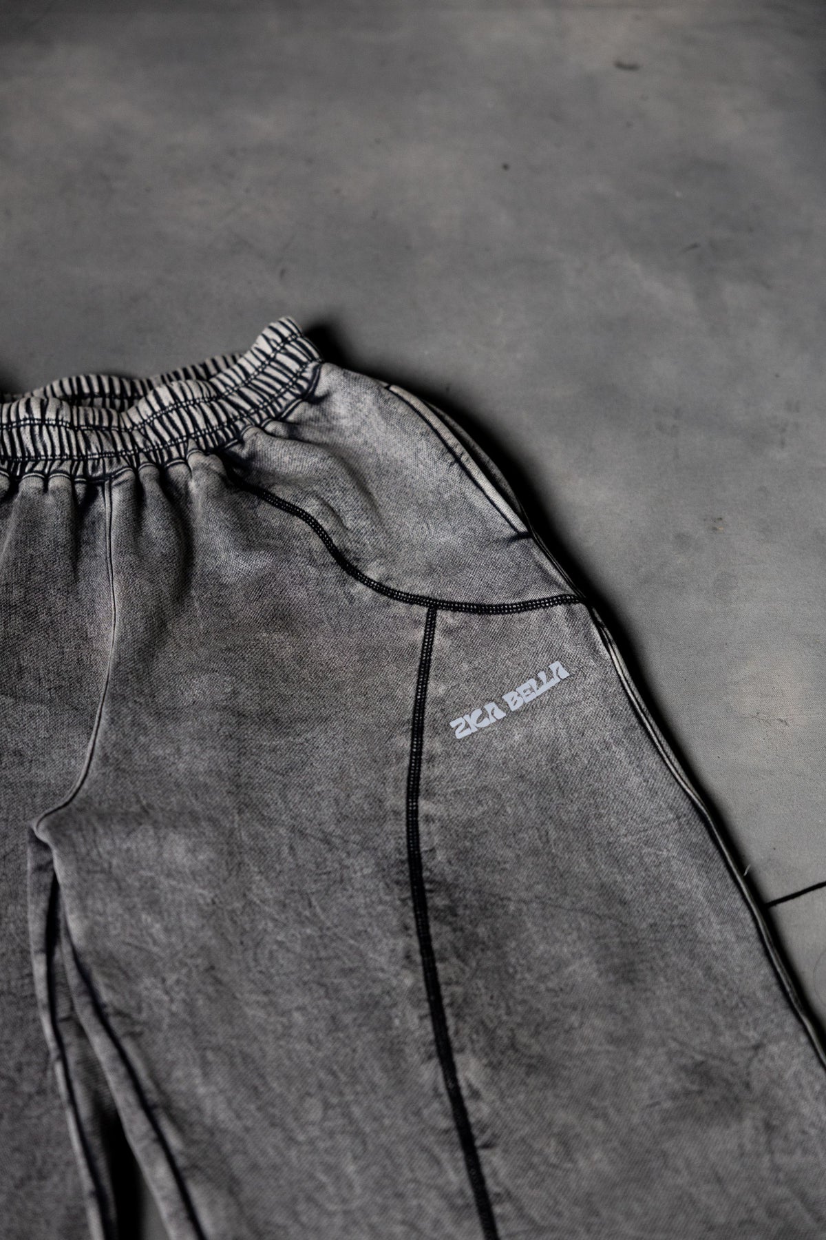 Close up stitching detail of grey baggy lower showcasing clean finish and quality build