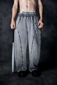 Front view of grey baggy lower featuring loose fit and elastic waistband for streetwear styling