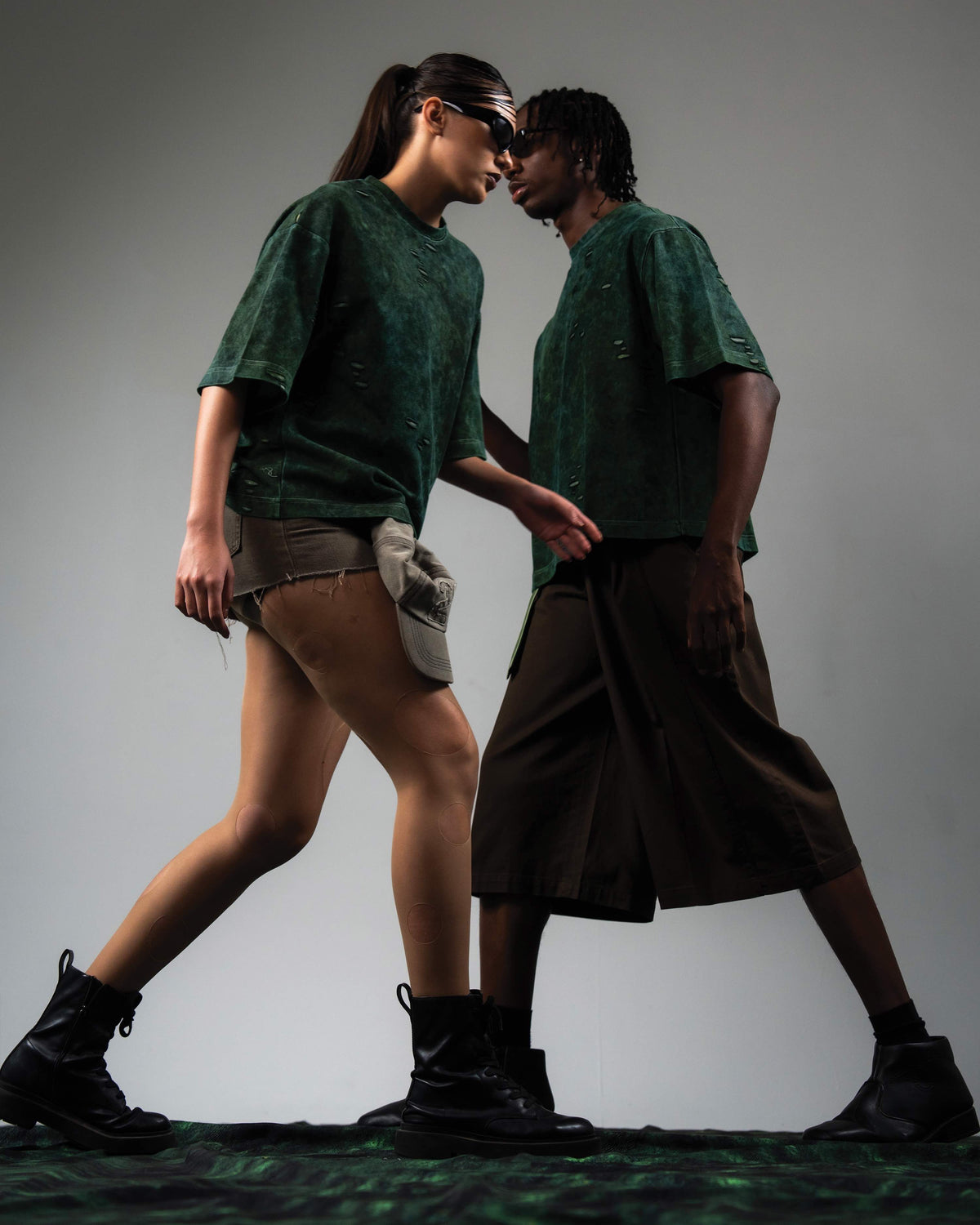 Editorial fashion pose featuring GRN_ERR green acid wash oversized tee