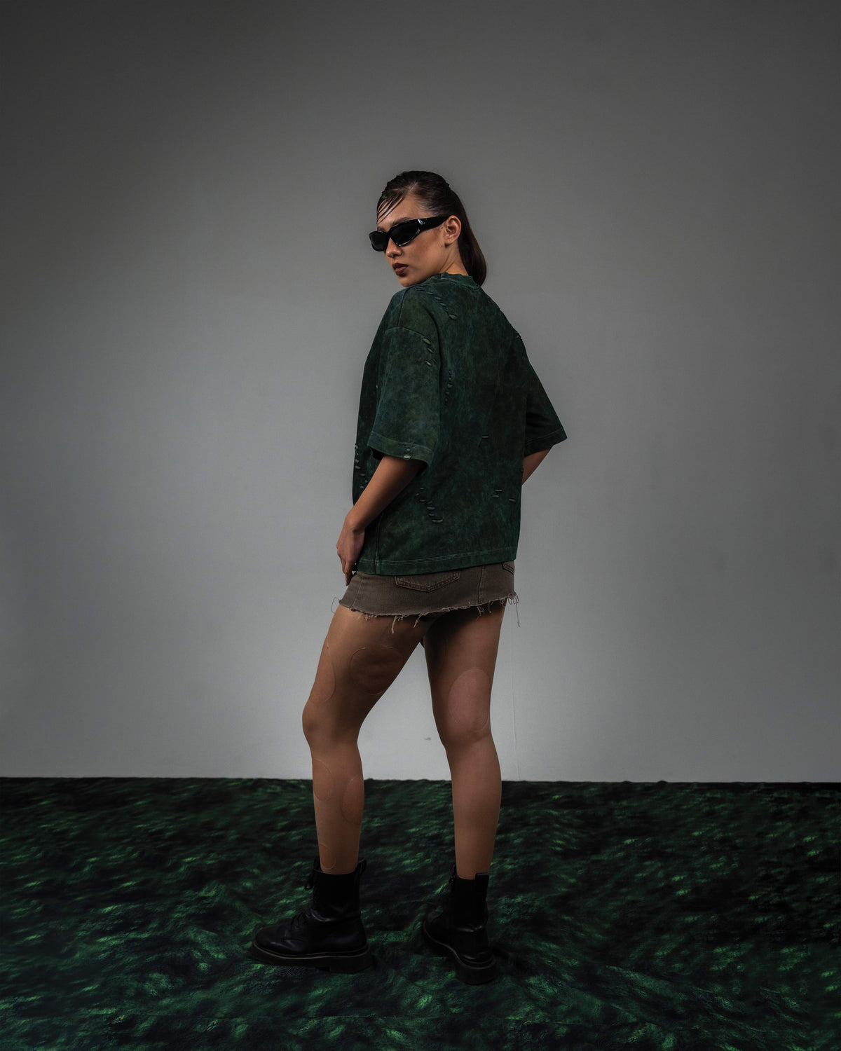 Female side back fit look in GRN_ERR green vintage wash streetwear t shirt