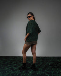 Female side back fit look in GRN_ERR green vintage wash streetwear t shirt