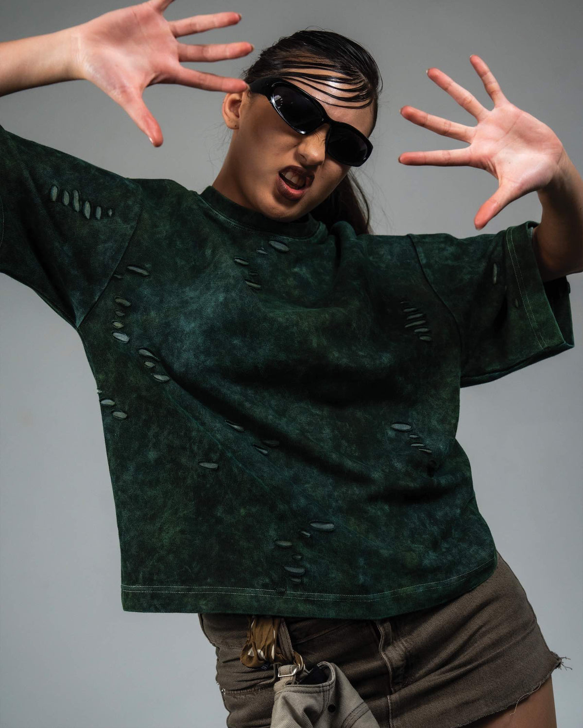Female model wearing GRN_ERR oversized green streetwear t shirt
