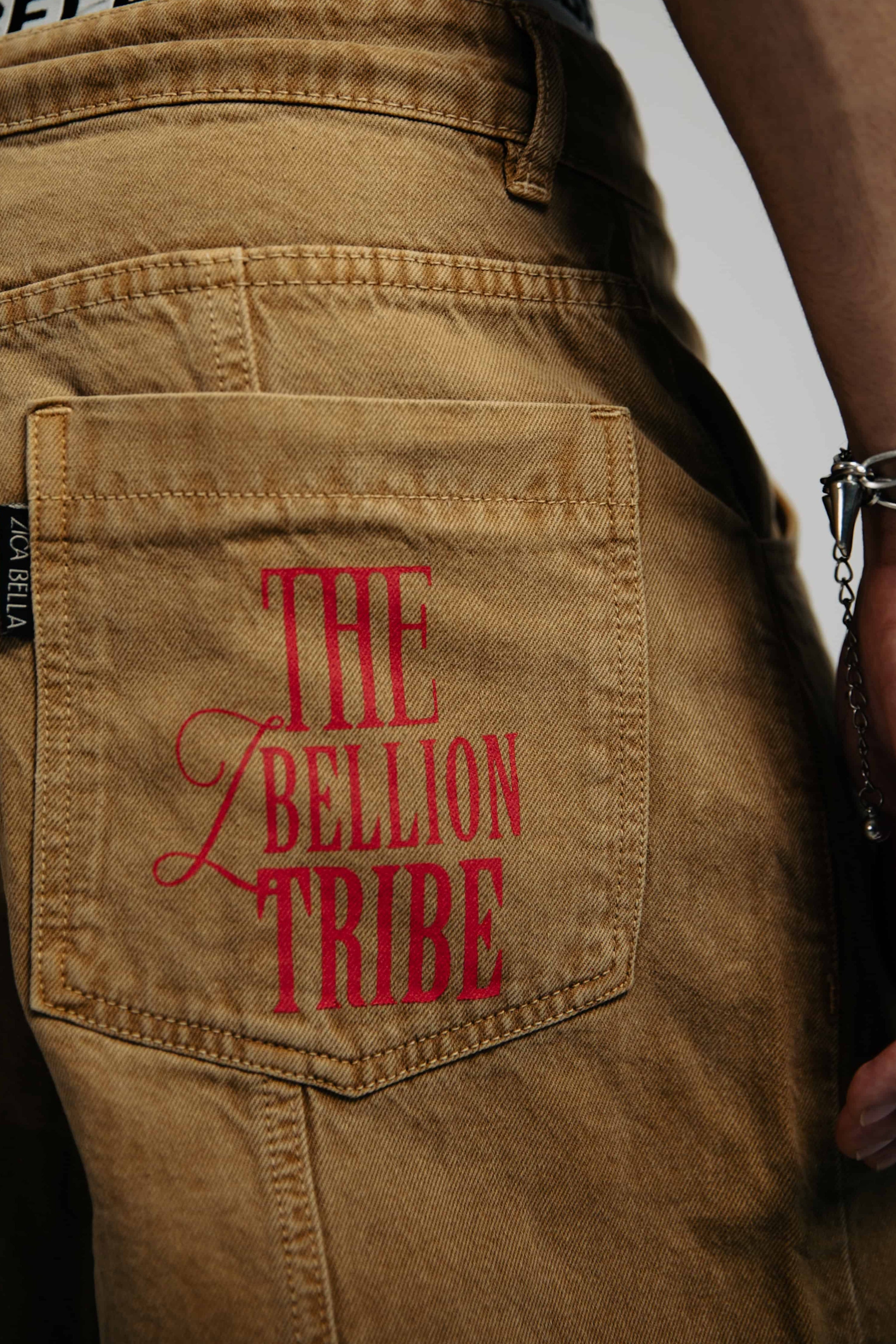 Beige denim jeans with a loose fit, featuring a unique back print design that elevates streetwear style