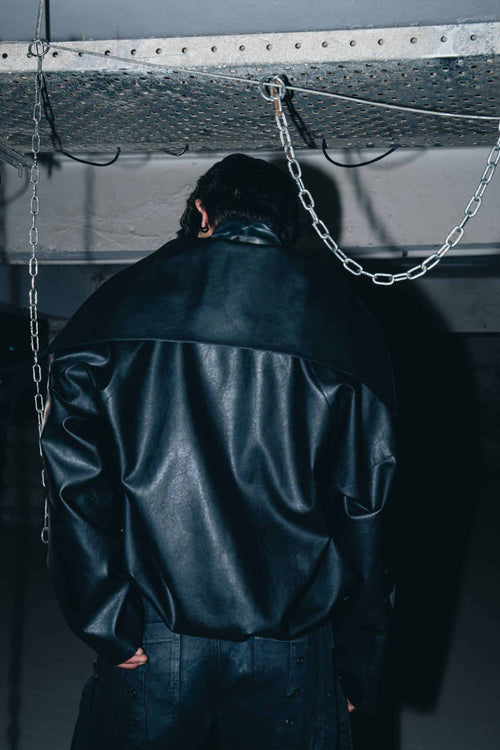 Luxury black leather biker jacket with minimalist design, offering a sleek and structured fit.