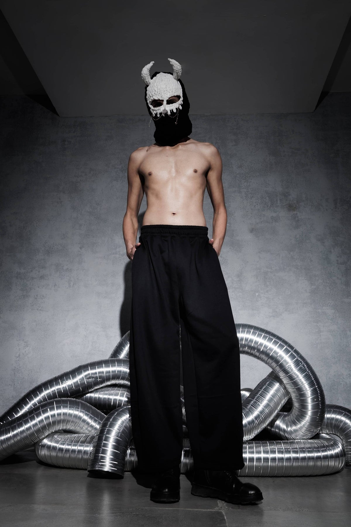 Men’s black streetwear joggers shown in front view with elastic waistband and wide leg fit, cotton polyester fabric pants styled in modern urban fashion
