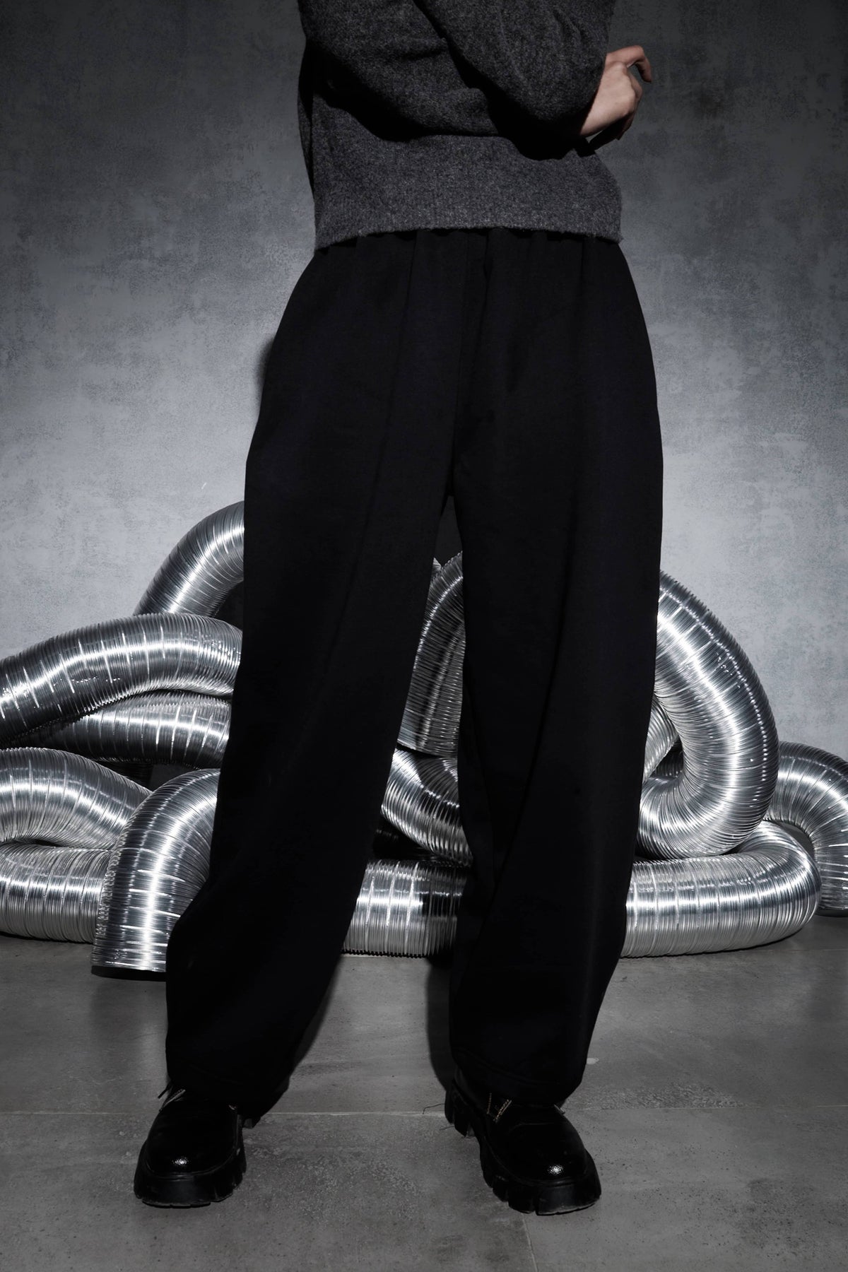 Men’s black streetwear joggers worn on body with relaxed wide leg fit, premium quality pants showing natural fall and modern urban street style