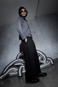 Men’s black streetwear joggers shown in side view with wide leg relaxed fit, cotton polyester fabric pants styled in modern urban fashion look