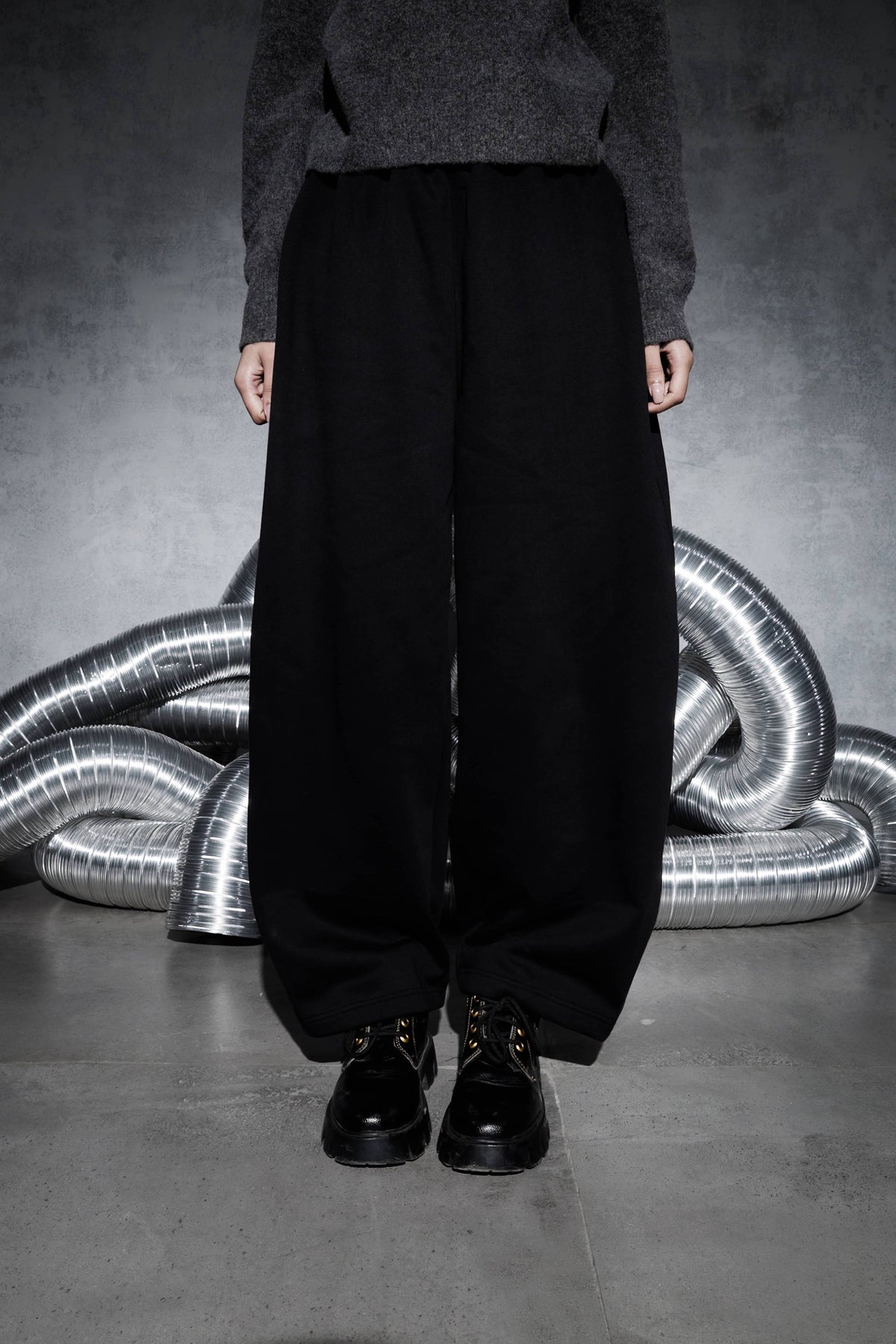 Men’s black wide leg streetwear joggers shown from front view, oversized relaxed fit pants highlighting full length silhouette and modern urban style