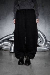 Men’s black wide leg streetwear joggers shown from front view, oversized relaxed fit pants highlighting full length silhouette and modern urban style