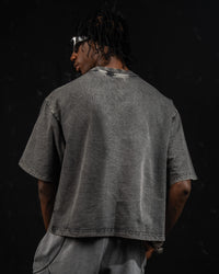 Studio back view of a washed charcoal oversized t-shirt highlighting the drop-shoulder fit