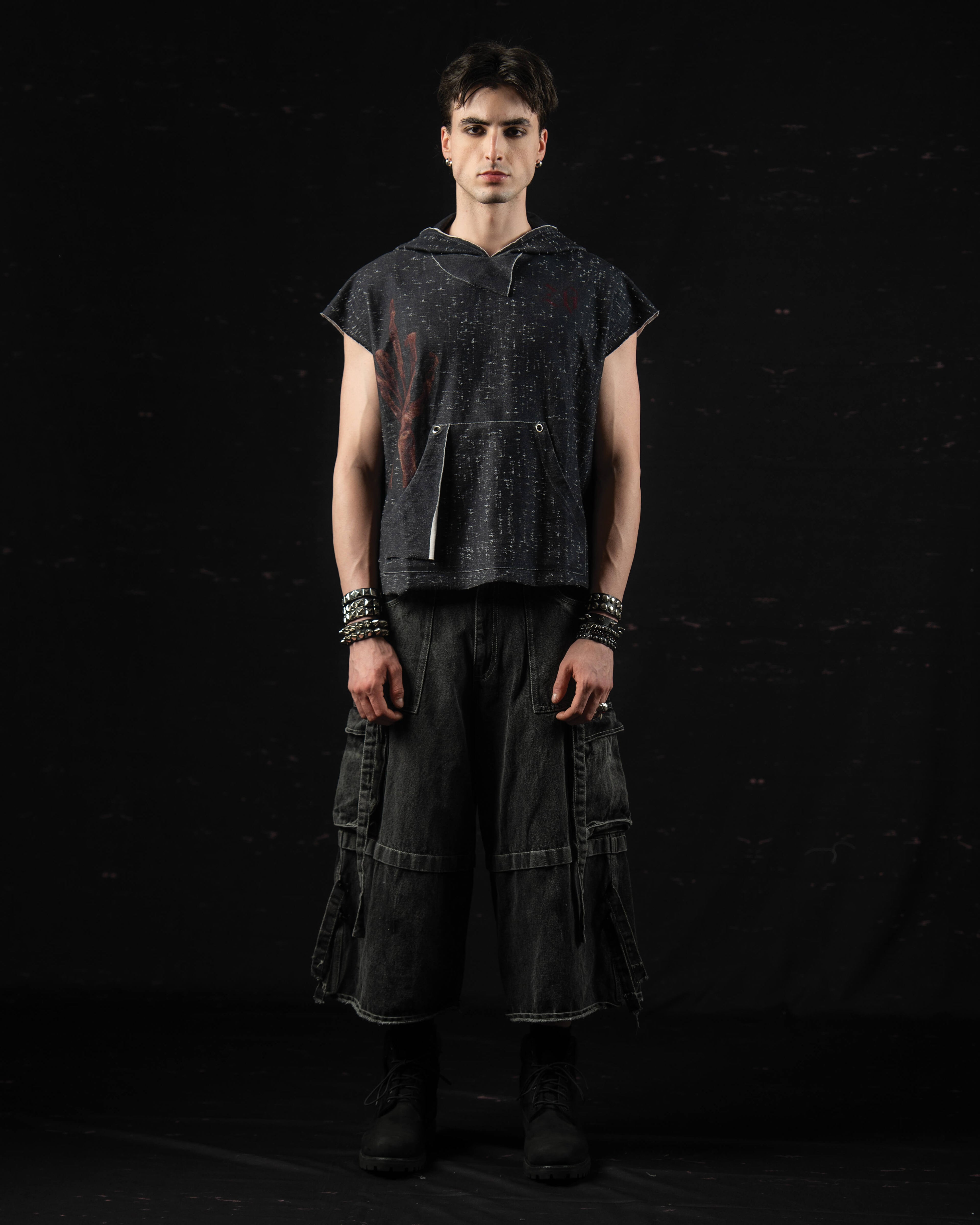 Studio front portrait of a model wearing a washed charcoal oversized hooded graphic t-shirt