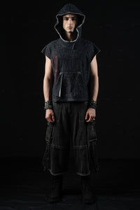 Front full-body portrait of a model wearing a washed charcoal oversized hooded graphic tee