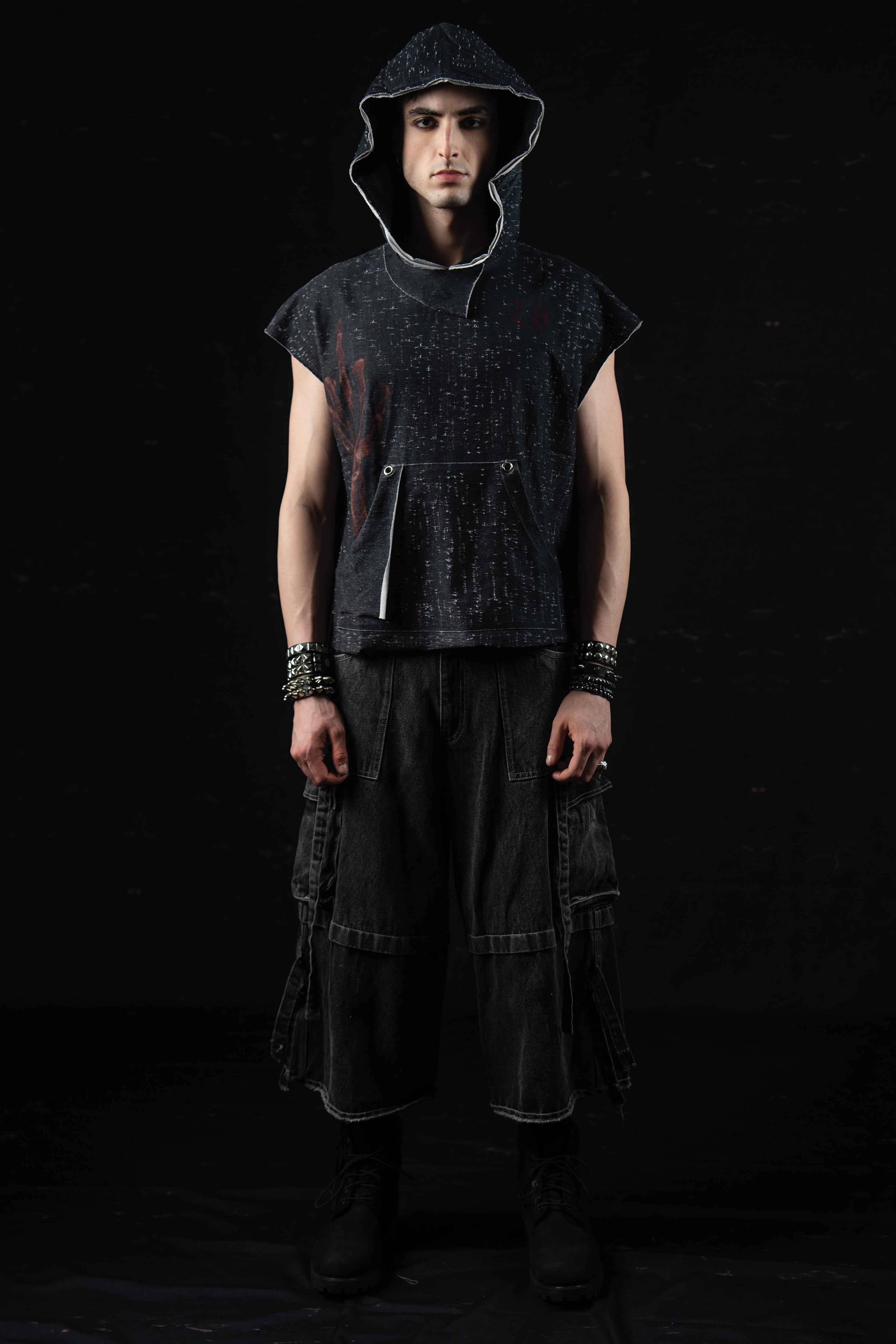 Front full-body portrait of a model wearing a washed charcoal oversized hooded graphic tee