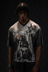 Studio portrait of a man modeling a grey and black oversized graphic jersey