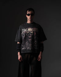 Clean studio front shot of a man wearing an oversized black skull graphic t-shirt in a relaxed fit