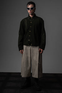 Full-length high-fashion portrait of a man styling a premium heavyweight dark olive textured shirt