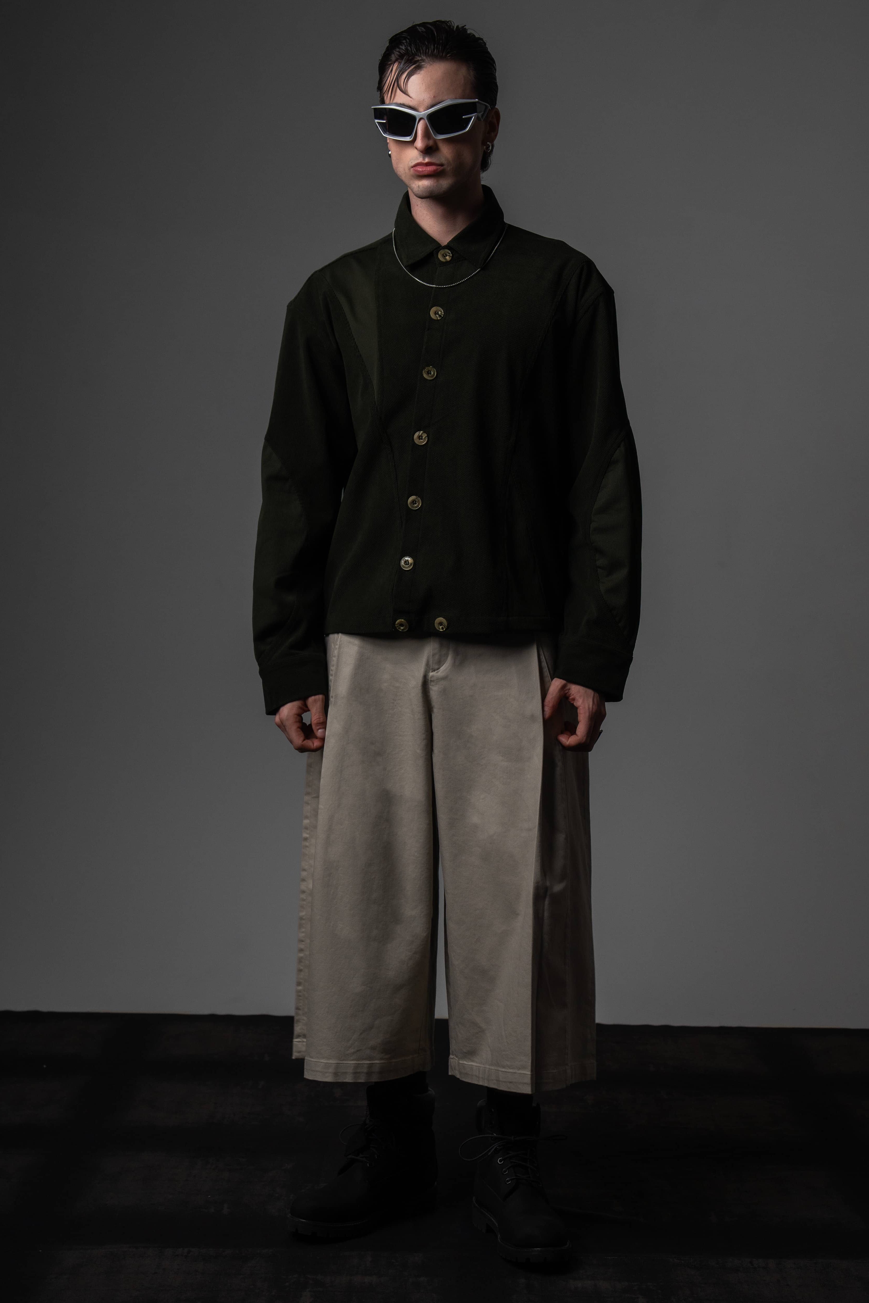 Full-length high-fashion portrait of a man styling a premium heavyweight dark olive textured shirt