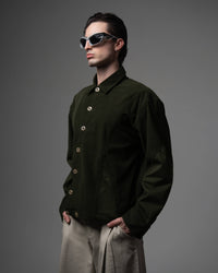 Side angle view highlighting the premium fabric texture of a men's dark olive shirt