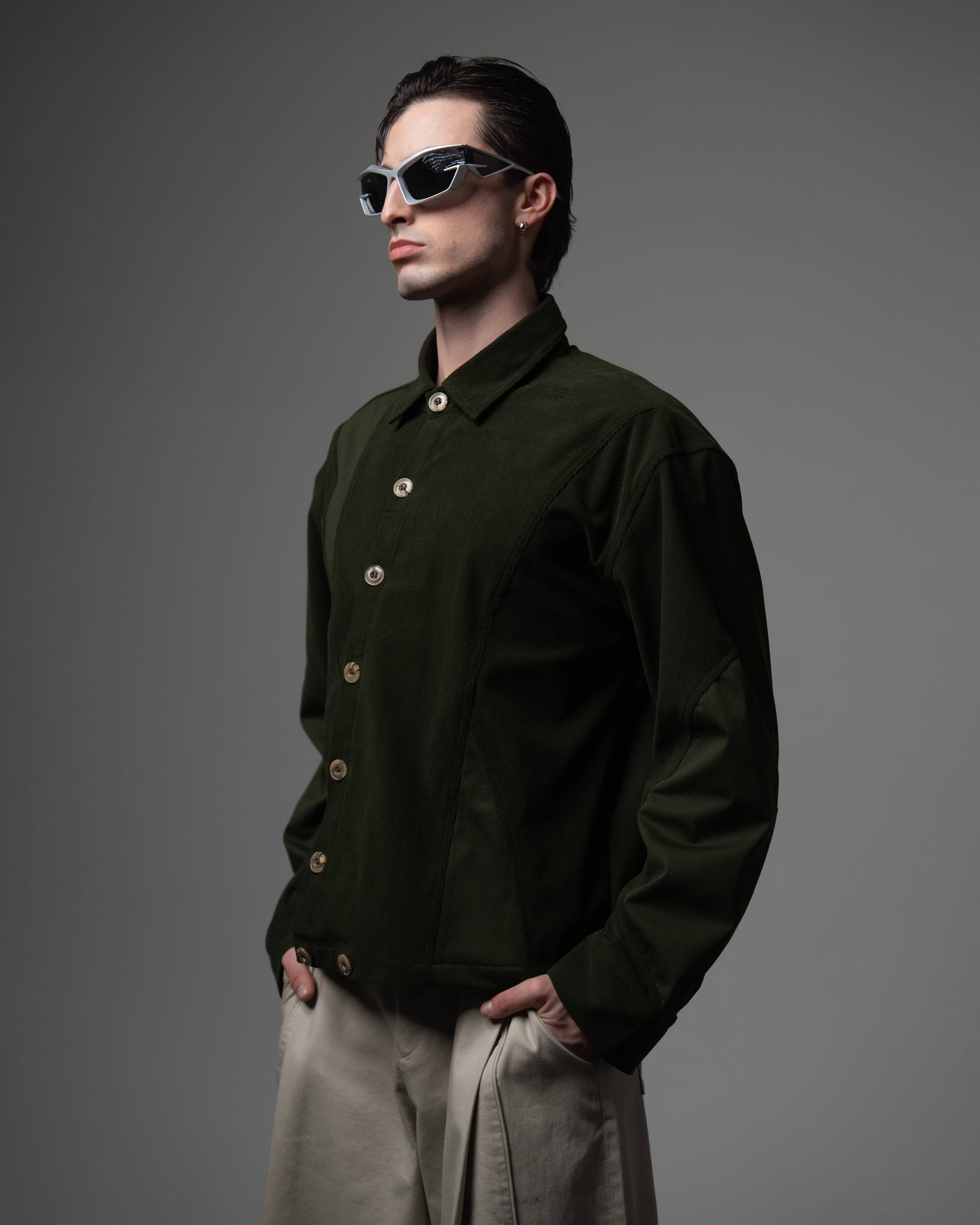 Side angle view highlighting the premium fabric texture of a men's dark olive shirt