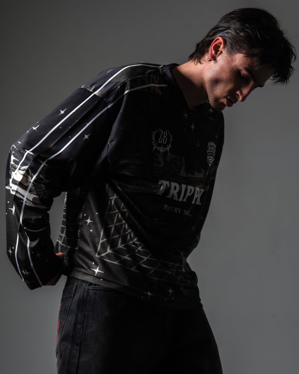Side angle portrait highlighting the 3D grid illusion print on the TRPPY_22 streetwear jersey